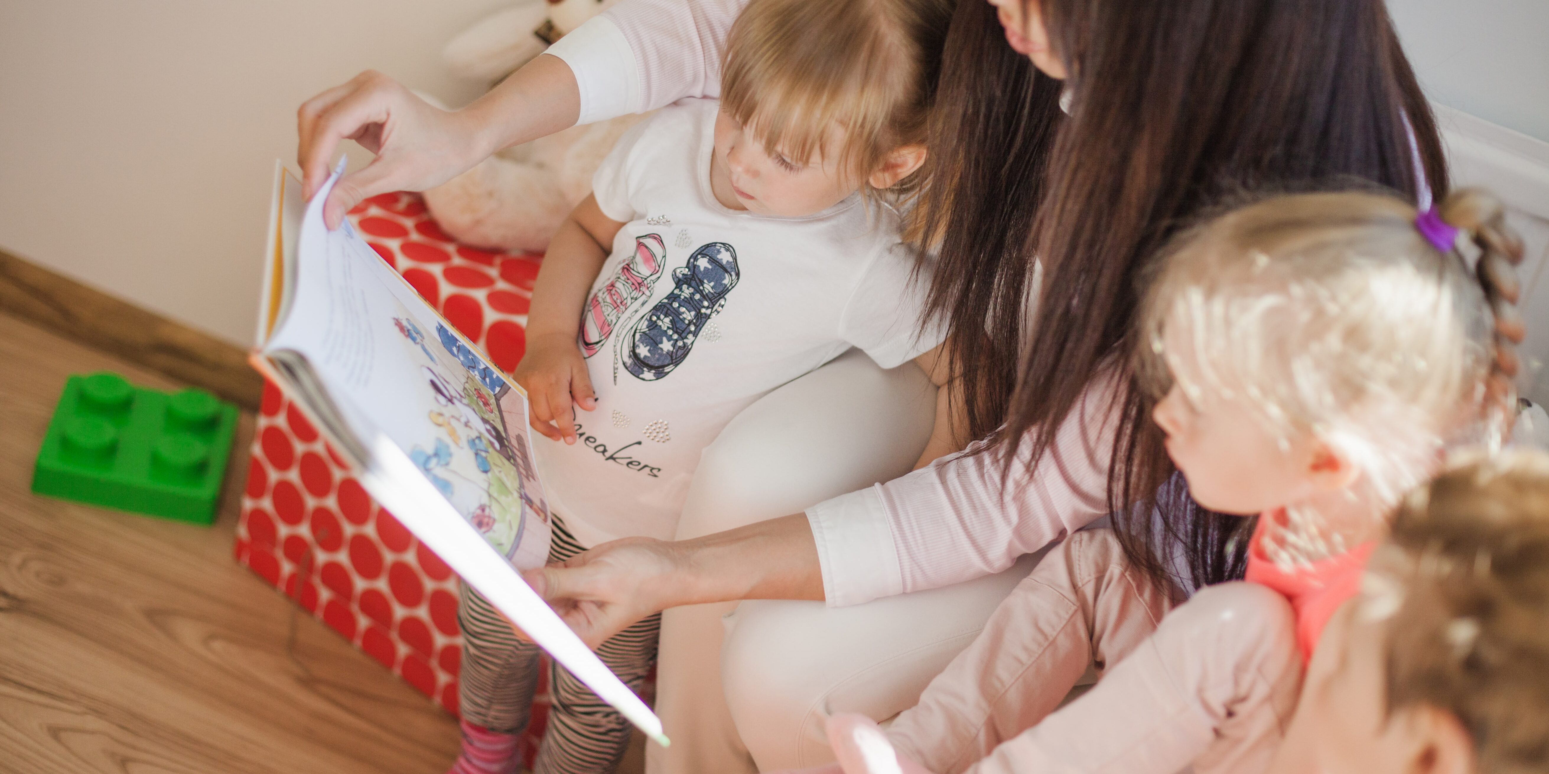 nurse-sitting-with-kids-reading-book