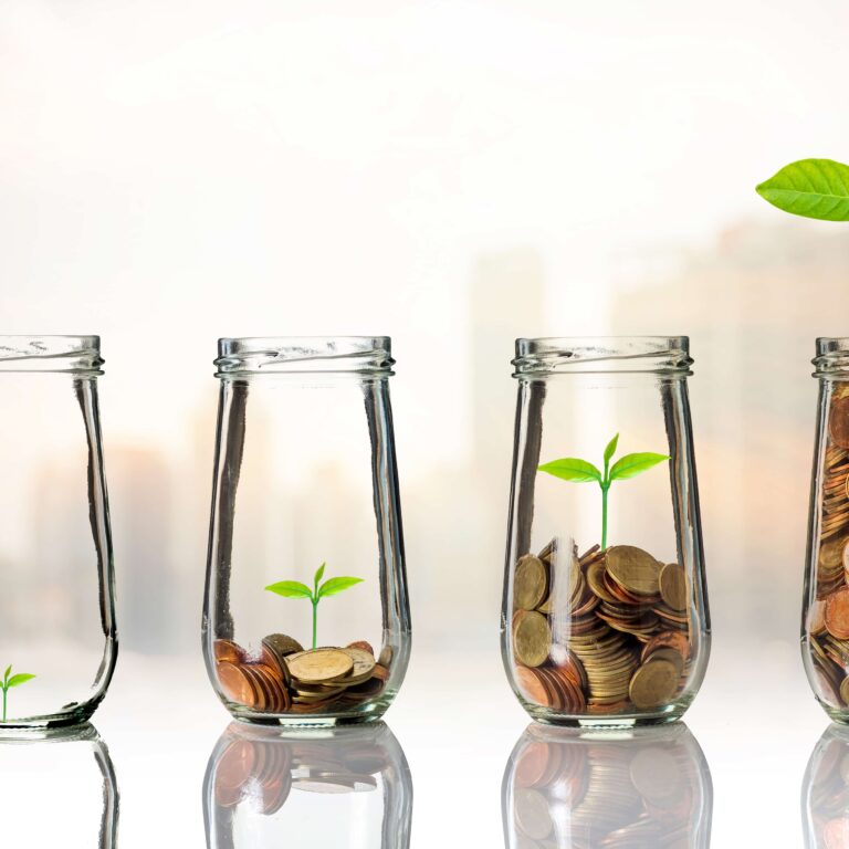 Gold coins and seed in clear bottle on cityscape photo blurred c