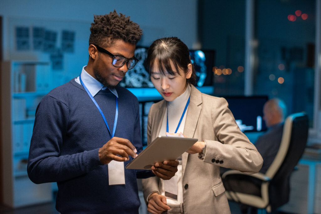 Two young interracial colleagues preparing presentation