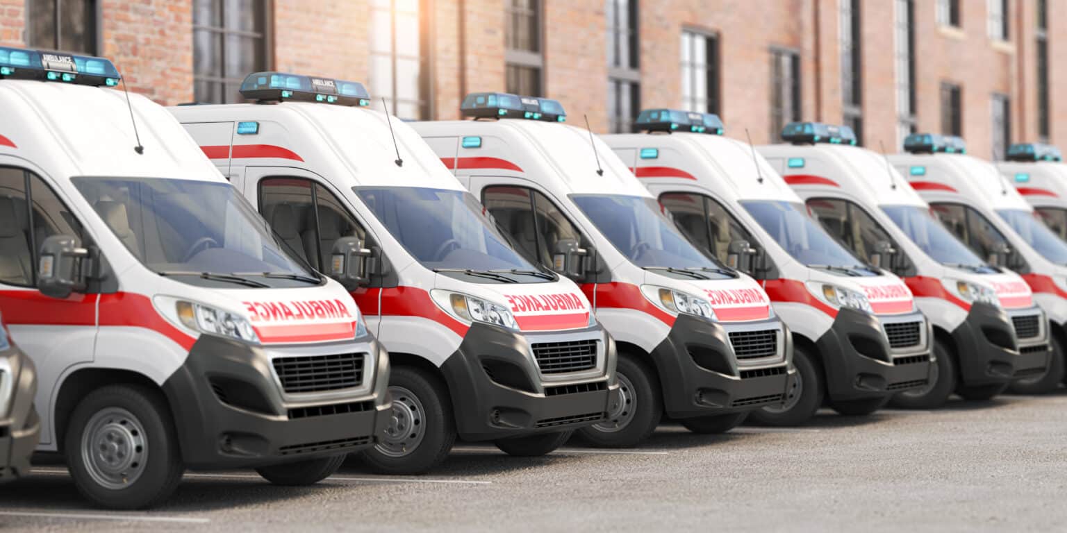 Ambulance cars in a row on a parking of hospital. 3d illustration